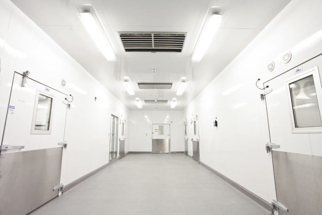 n empty scientific clean room designed for controlled environments featuring IMPs for sterile environments.