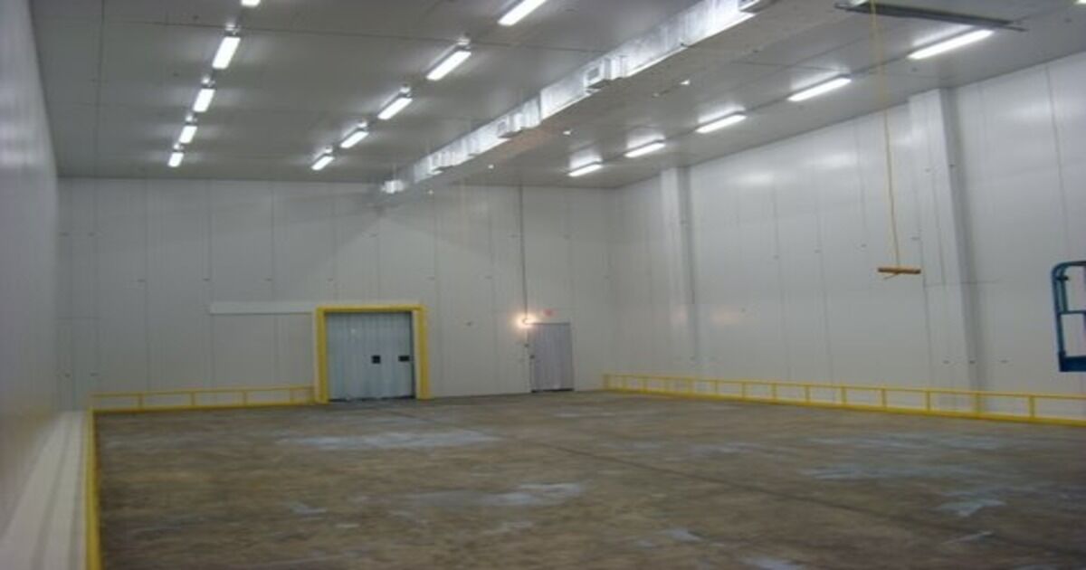 empty refrigerated warehouse with fluorescent lighting