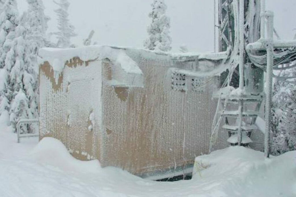 outdoor equipment enclosure covered in deep snow