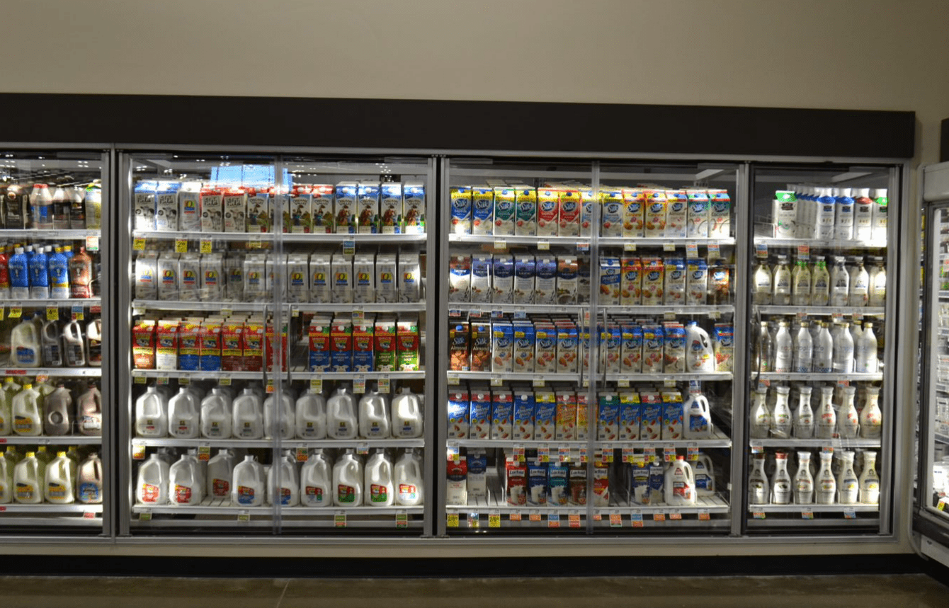 grocery store cooler with reach in glass doors to showcase merchandise