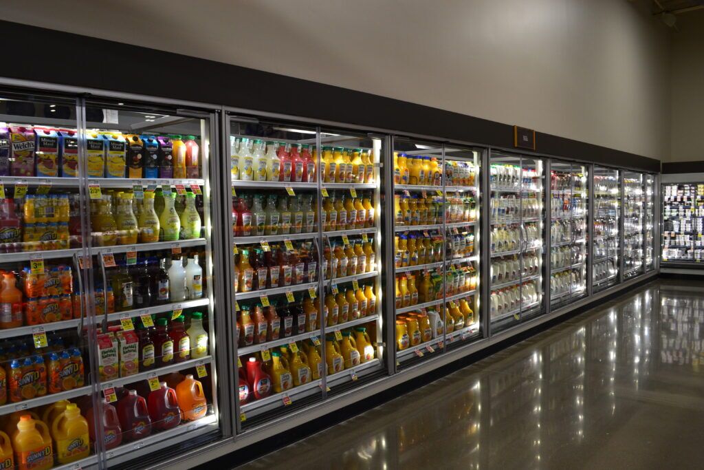 grocery store cooler filled with different beverages